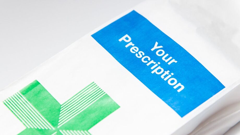 NHS prescription bag on a counter